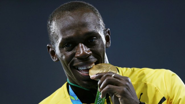Usain Bolt poses with the Gold Medal